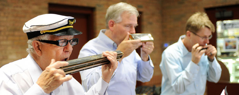 The Reed City Halwalker's Harmonica Quartet performs in Acorn Alley during the 2012 Kent State Folk Festival.