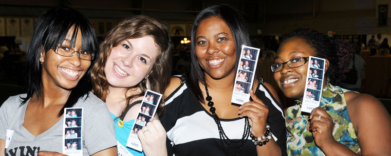 Kent State graduates display photos of themselves taken in a photo booth at the Flashes Forever event Friday night in the Fieldhouse.