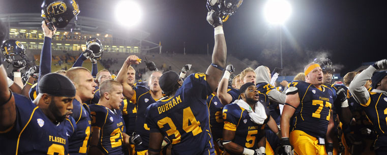 Kent State players celebrate on the field following a 24-21 win over visiting Central Michigan at Dix Stadium.