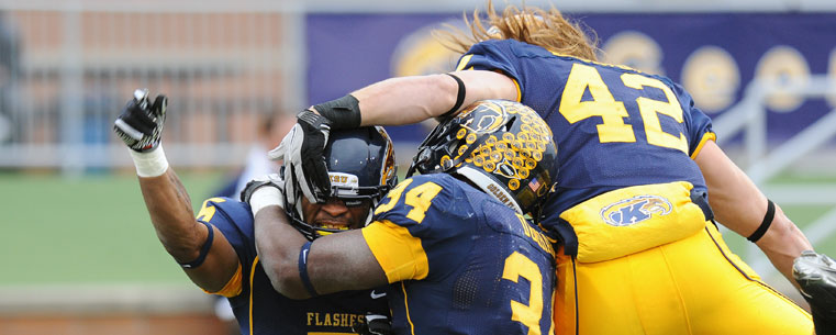 Kent State wide receiver Chris Gilbert and teammates celebrate the Golden Flashes go-ahead score in the fourth quarter of the 28-22 victory at Dix Stadium.