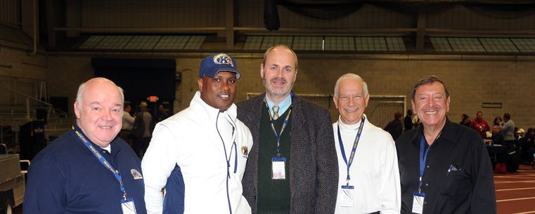 Kent State head football coach Darrell Hazell (second from left) and Kent State Senior Vice President for Academic Affairs and Provost Todd Diacon (center) gather with Vice President Vincent Hetherington (far left), President Thomas Melillo (far right) and Executive Vice President David Nicolanti (second from right) of the Ohio College of Podiatric Medicine in the Kent State Field House.