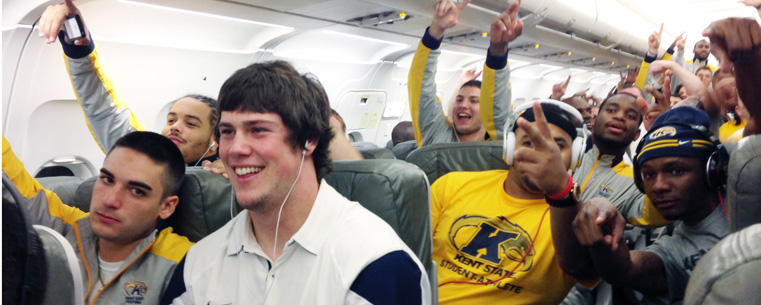 Kent State's Golden Flashes celebrate their 35-23 victory over Rutgers on their flight home from High Point Stadium.