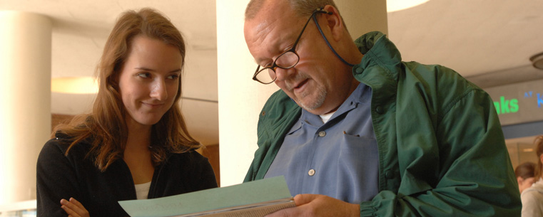 <p>A Kent State University student and her parent look over campus information during a Parents’ and Family Day visit.<br />
</p>