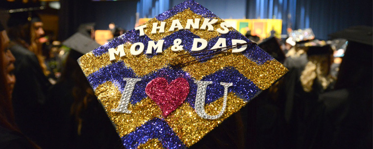 <p>A Kent State graduate's hat displays a note to her parents at the morning commencement ceremony on May 11, 2013.</p>