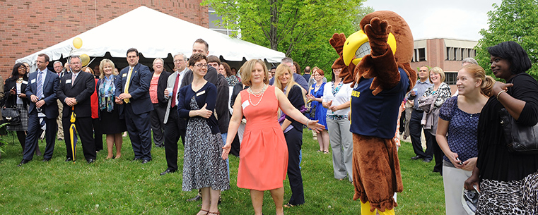 Guests attending the Sciences Building groundbreaking ceremony at Kent State University at Stark recognize an appearance by Flash, the official Kent State mascot, during the event.