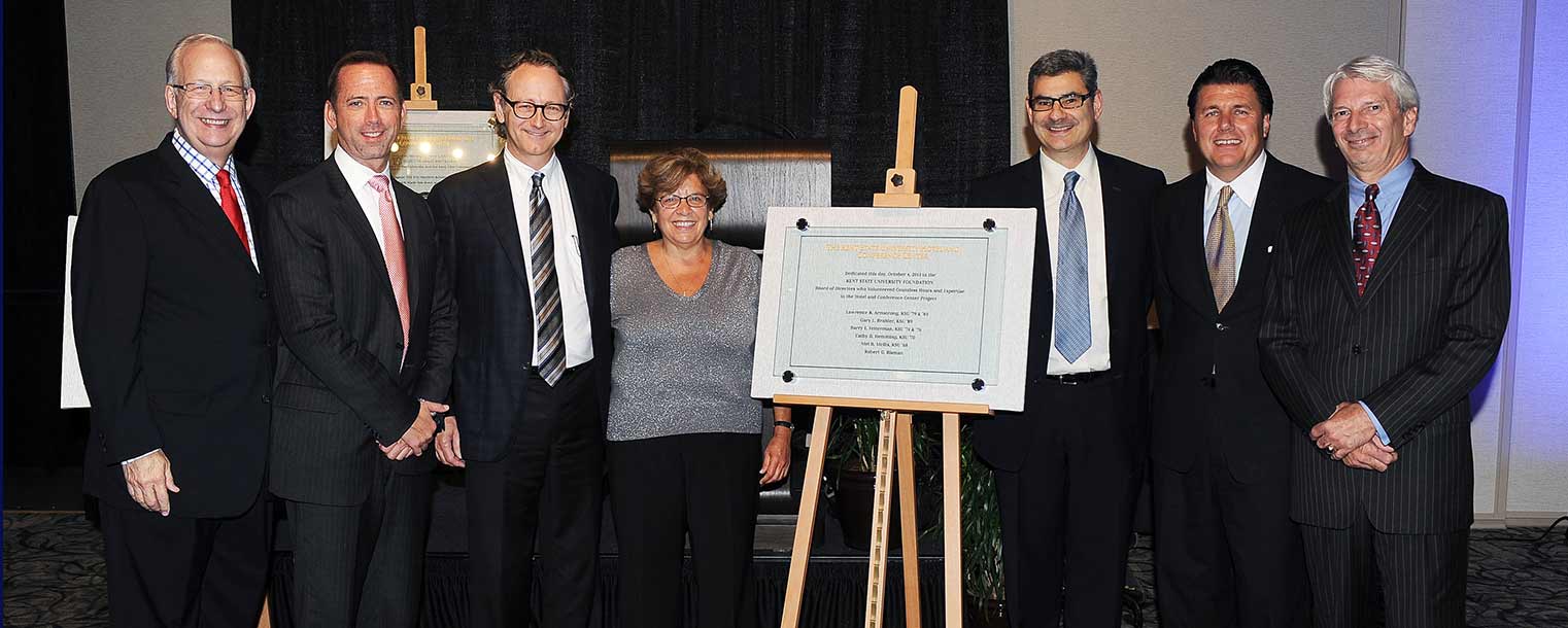 Kent State President Lester A. Lefton stands with the university's Foundation Board in the new Kent State University Hotel and Conference Center during the hotel's grand opening celebration.