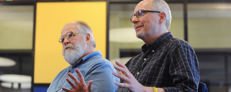 Chuck Ayers (left) and Tom Batiuk(right) respond to questions during interviews in The Nest, the new student lounge in the Kent Student Center. The lounge features art created by the two Kent State University alumni.