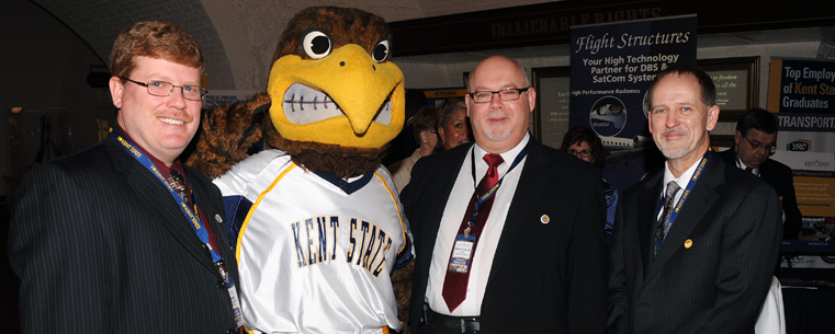 <p>Flash, the Kent State mascot, gathers for a photo with Kent Economic Development Director Dan Smith (left), Trustee Stephen Colecchi and Kent State Vice President for Research Grant McGimpsey in the Ohio Statehouse.</p>