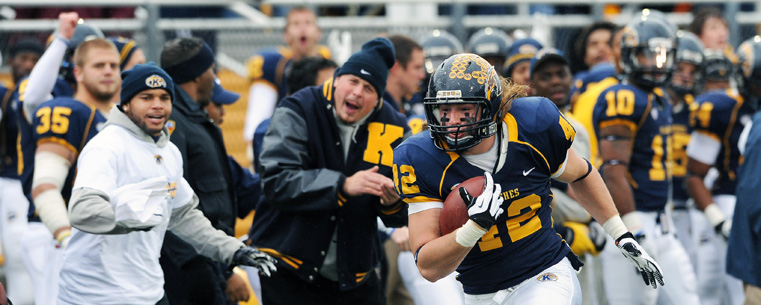 Kent State's Tim Erjavec rides the sideline after a catch, cheered on by teammates, during Kent State's 35-24 win over the University of Akron.