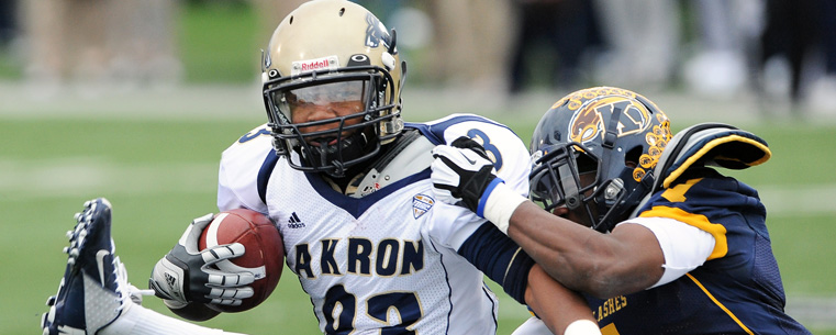 The Kent State defense swarms a University of Akron player during a 35-24 win at Dix Stadium.