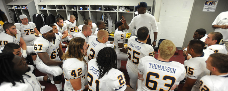 <p>Coach Darrell Hazell gives the Golden Flashes a last minute talk before the Alabama game.</p>