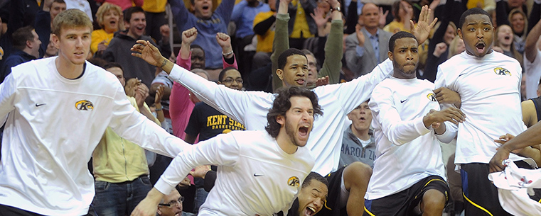 The Kent State bench erupts in celebration near the end of a hard-fought 70-68 victory over Buffalo in the MAC Tournament in Cleveland.