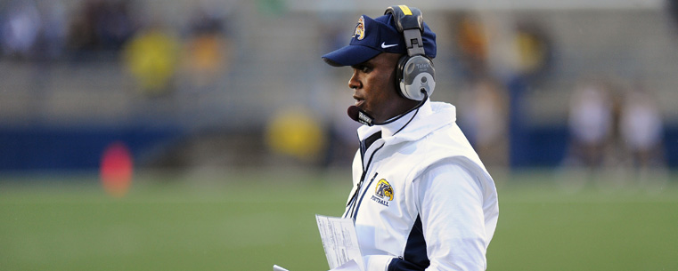 <p>Coach Darrell Hazell surveys the field.</p>