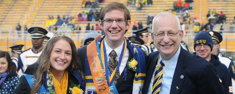 President Lefton congratulates Homecoming King Tom Ream and Queen Ann Miller during the halftime ceremony at Dix Stadium.