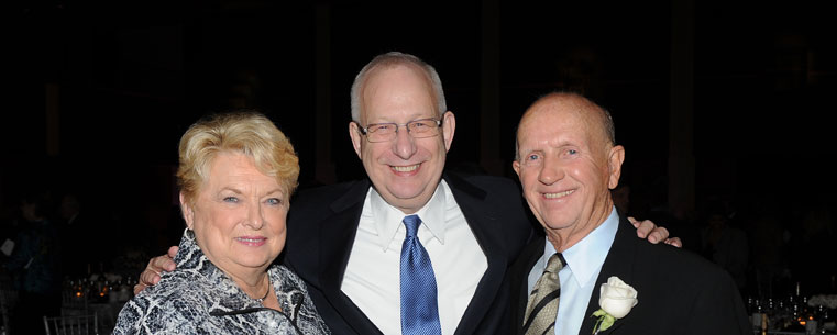 President Lester A. Lefton embraces donors Walter and Judy Van Benthuysen during the 2011 Founders Gala, which was held in the Kent Student Center Ballroom.