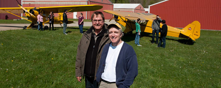 Pilots Joe Murray and Ron Siwik are pictured at the Portage County Airport with the two 1946 Piper J3 Cub aircraft they will fly to Dayton-Wright Brothers Airport. (Photo courtesy of Gary Harwood)