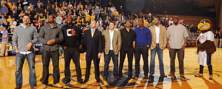 Members of the 2002 Elite Eight basketball team reunite on the floor of the Memorial Athletic and Convocation Center, during a game against the College of Charleston.