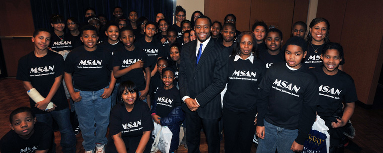 <p>Keynote speaker Dr. Marc Lamont Hill gathers for a photo with local students following the Martin Luther King Jr. Celebration in the Kent Student Center Ballroom.</p>