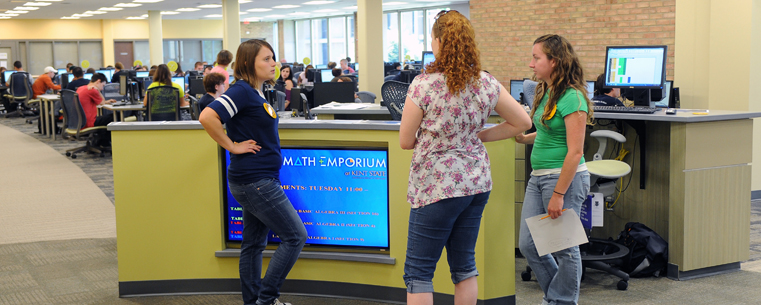 <p>Members of the instructional team discuss techniques at the information desk in the new Math Emporium, located on the second floor of the University Library.</p>