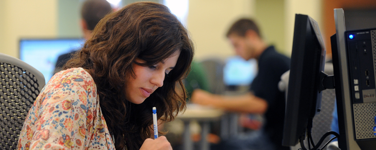 <p>A Kent State student focuses on her assignment in the new Math Emporium, located on the second floor of the University Library.<br />
</p>