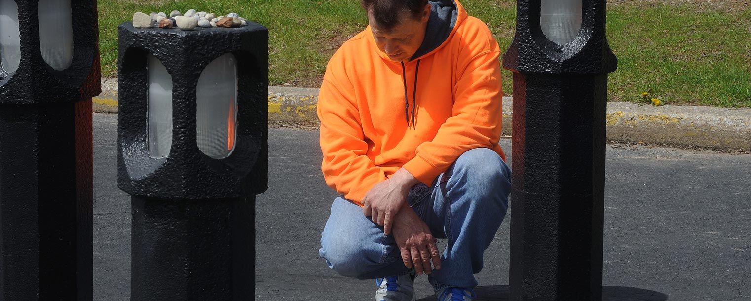 Ravenna resident John McPeek, a graduate of Kent State University, prays at the spot where Jeffrey Miller was killed 44 years ago by Ohio National Guardsmen during anti-war protests on May 4, 1970.