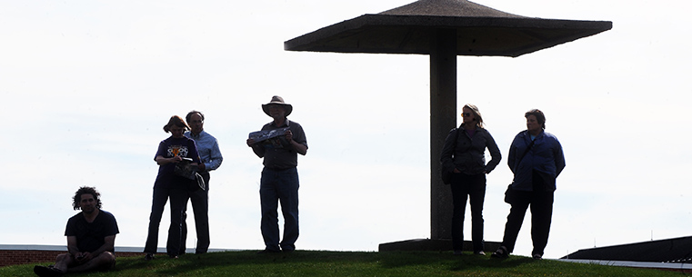 Visitors to the 43rd annual May 4 Commemoration on the Kent State campus study the view from the pagoda near Taylor Hall where Ohio National Guardsmen opened fire.