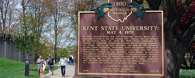 Visitors to the 43rd annual May 4 Commemoration on the Kent State campus walk by the Ohio Historical marker positioned near the Taylor Hall parking lot.