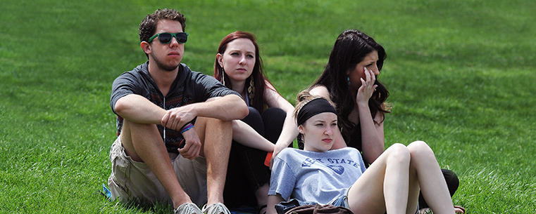 A group of students listen to emotional accounts of May 4, 1970, at Kent State while attending the 43rd annual May 4 Commemoration on the Commons near Taylor Hall.