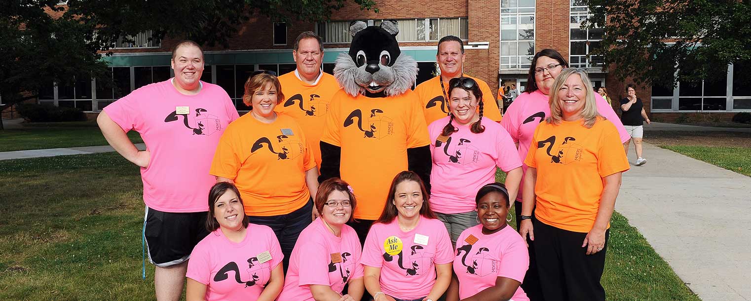 Kent State executive officers, students and Skip, the black squirrel, wait for a new round of incoming freshmen during move-in day at the residence halls.