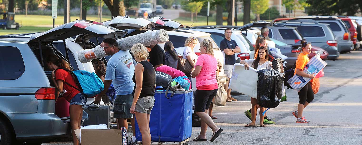 Cars, new Kent State students and parents line the parking lot near Manchester Hall early in the day during the first of two move-in opportunities for incoming freshmen.