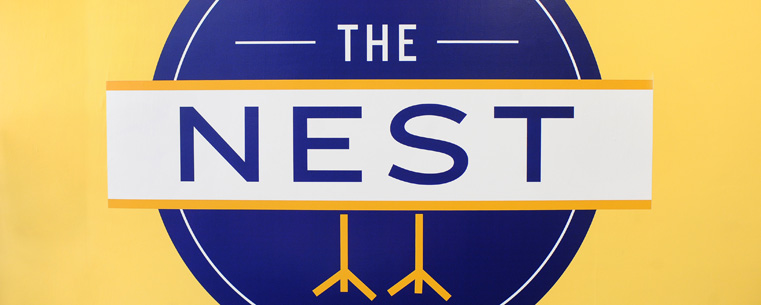 The newly installed logo for The Nest adorns the wall of new student lounge located on the second floor of the Kent Student Center.