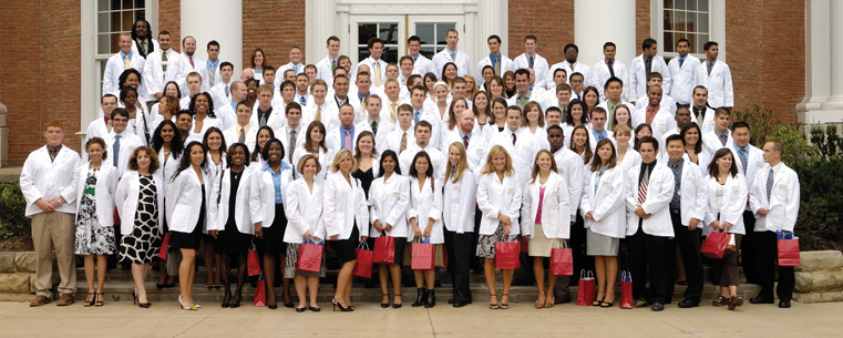 Students from the Ohio College of Podiatric Medicine pose for a class photo on the college's front steps following a White Coat Ceremony. The White Coat Ceremony signifies the transition from undergraduate and/or pre-professional life to the start of a professional life. (Photo courtesy of the Ohio College of Podiatric Medicine)