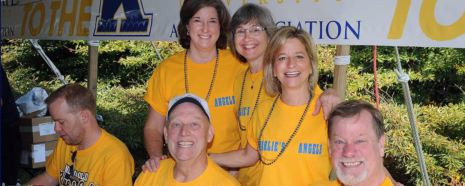 Charlie Thomas, ’74, owner of Ray’s Place in downtown Kent, poses with “Charlie’s Angels" and book author Patrick J. O’Connor during the Kent State Alumni Association breakfast.