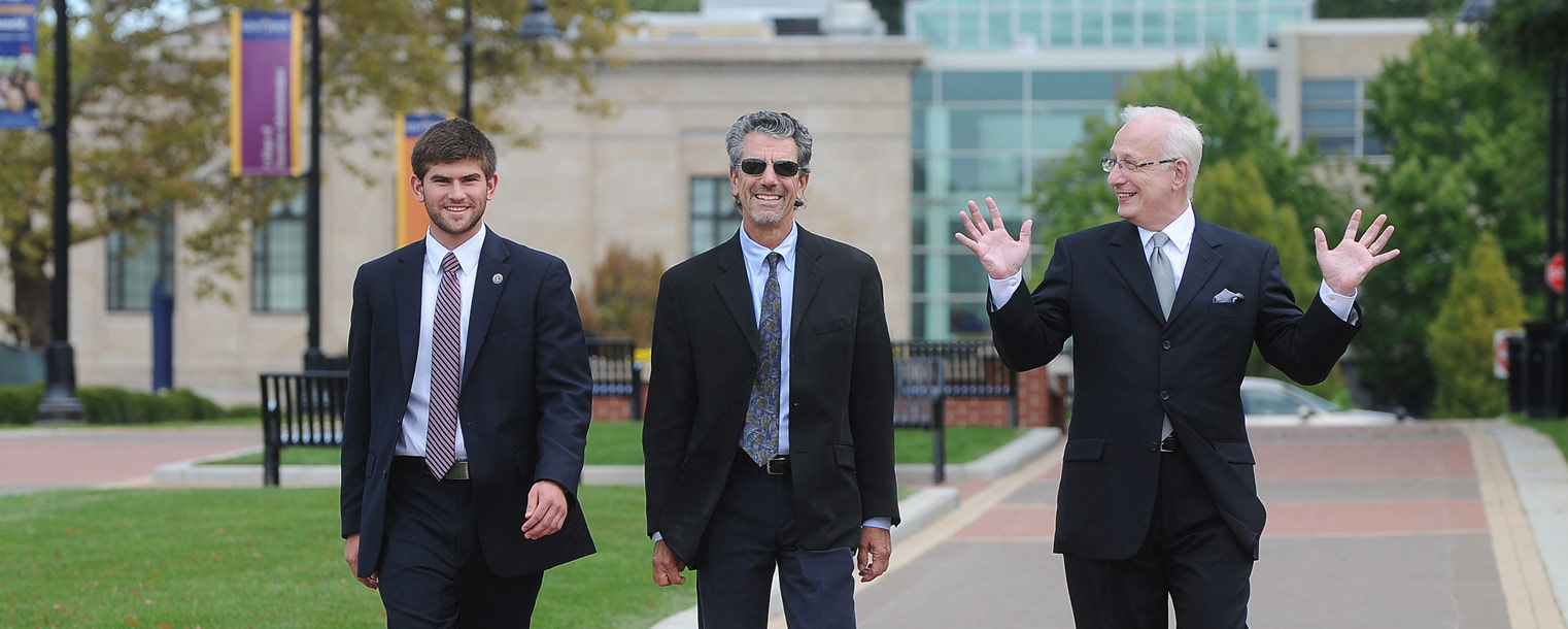 Kent State University Undergraduate Student Trustee Alex Evans, National Trustee Michael Solomon and President Lester A. Lefton take a stroll down the Kent State University Esplanade that now connects the university to downtown Kent. Seen in the background is Rockwell Hall.