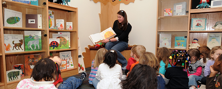 Elizabeth Miyajima, a student in Kent State’s School of Library and Information Science (SLIS), reads to a group from the university’s Child Development Center in the Marantz Picturebook Collection room in SLIS.