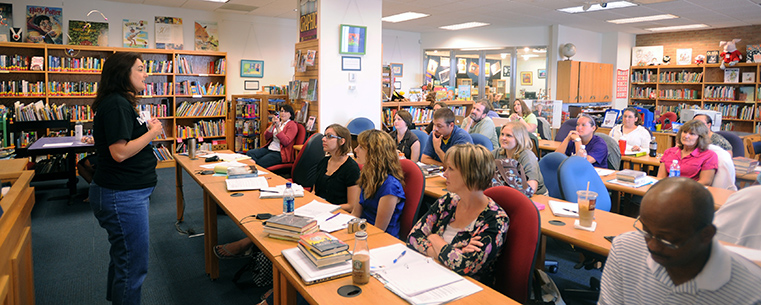 Local teachers present findings during a conference in the Reinberger Children’s Library Center in the Kent State University Library.