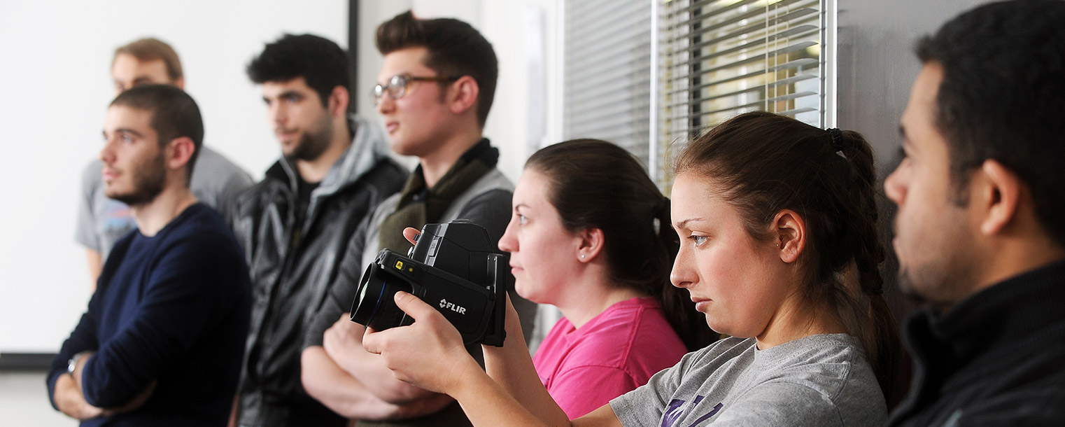 Students in Elwin Robison’s architecture class take turns using a thermal imaging camera in Taylor Hall.