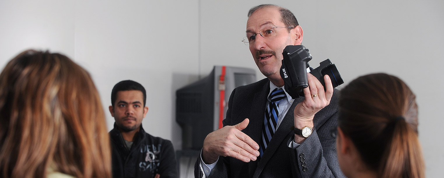 Elwin Robison, a professor in Kent State’s College of Architecture and Environmental Design, explains the operation of a thermal imaging camera to his architecture class in Taylor Hall.