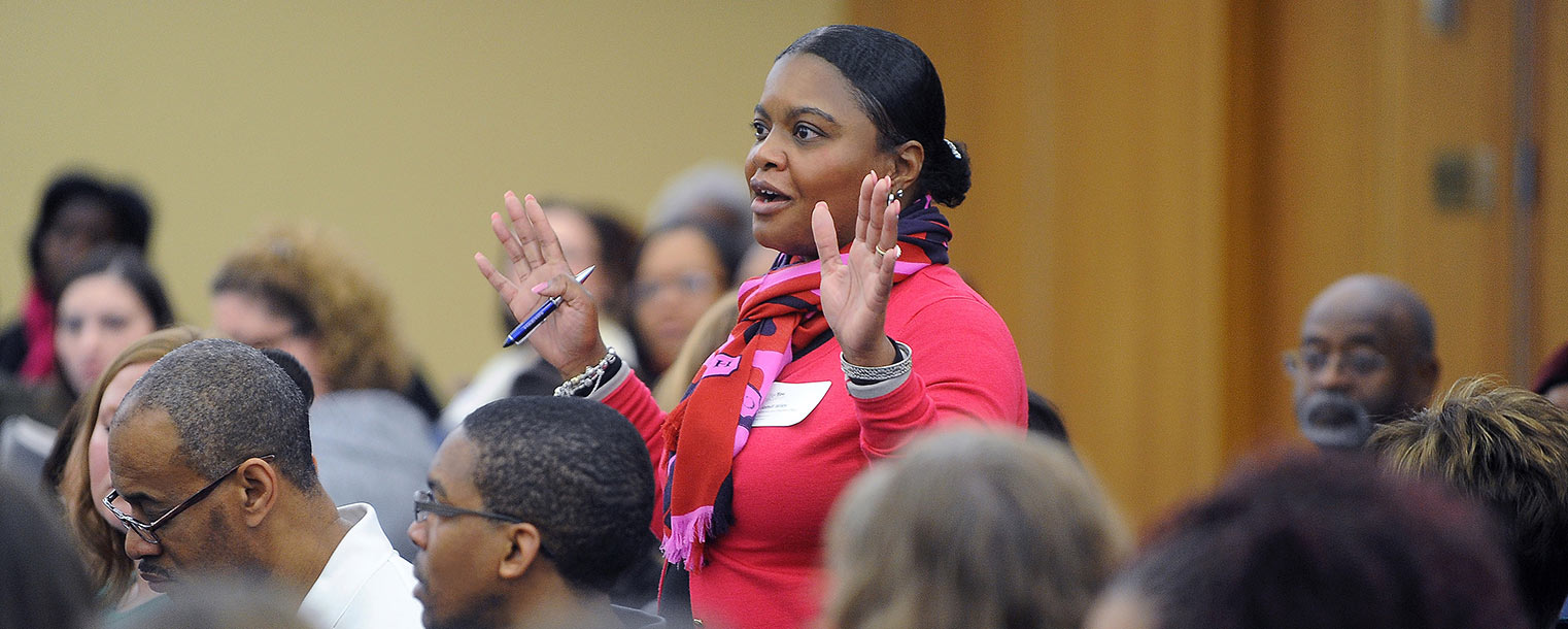 An audience member offers feedback during a panel discussion about why college is important and how society can make it an expectation for students now and in the future.