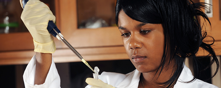 A Kent State student researcher conducts an experiment in a science lab on the Kent Campus.