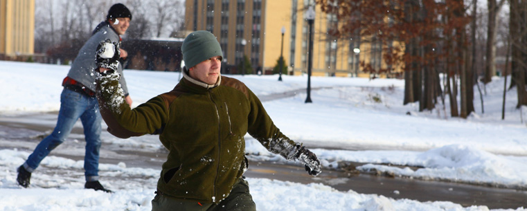 Students participate in a snowball fight on Manchester Field near Centennial Court.