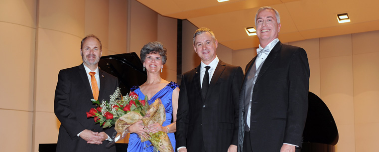 Kent State University Senior Vice President for Academic Affairs and Provost Todd Diacon, Kent State School of Music Director Denise Seachrist, Steinway and Sons President Ron Losby and Kent State College of the Arts Dean John R. Crawford pose for a picture after Losby presented Seachrist with flowers and announced the All-Steinway designation.