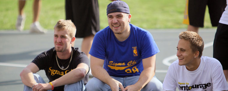 Returning students take a break from pick-up basketball games on the court near the Centennial Court residence halls.