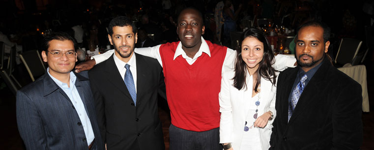 A group of friends gather for a photo during a student awards dinner.