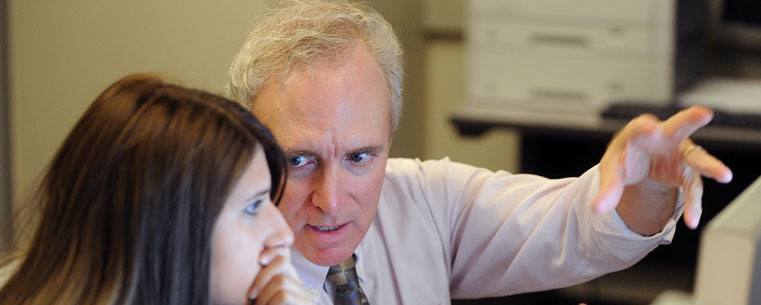 Professor Gordon Murray helps a student with a computer program and classroom assignment in Franklin Hall.