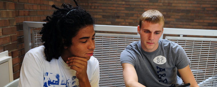 Two students review class notes prior to an exam in the College of Business.