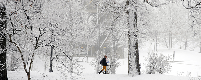 A Kent State student makes her way to class on a snowy winter morning near Ritchie Hall.