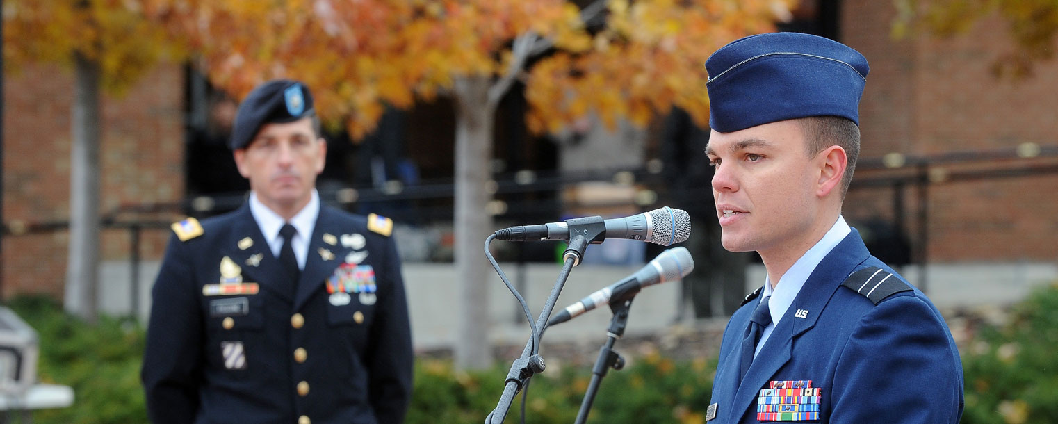 Kent State student Andrew Altizer speaks on behalf of veterans during university’s 2013 Veterans Day observance on Risman Plaza. Listening to Altizer is Lt. Col. Mark Piccone of the Kent State ROTC.