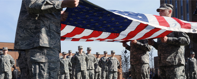 Members of the Kent State ROTC detachment stand at attention during the raising of the United States flag, over Risman Plaza.