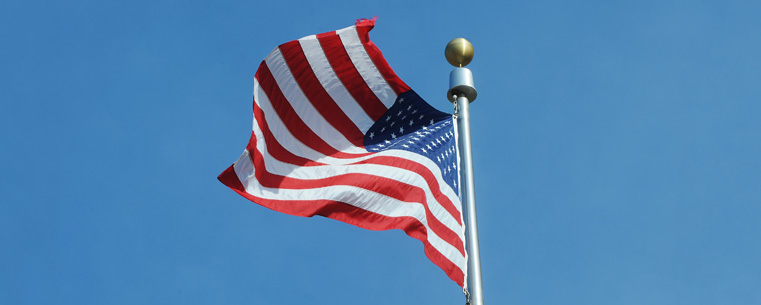 The American flag waves in the breeze in Risman Plaza after being raised by Kent State ROTC students participating in the annual Veterans Day ceremony.